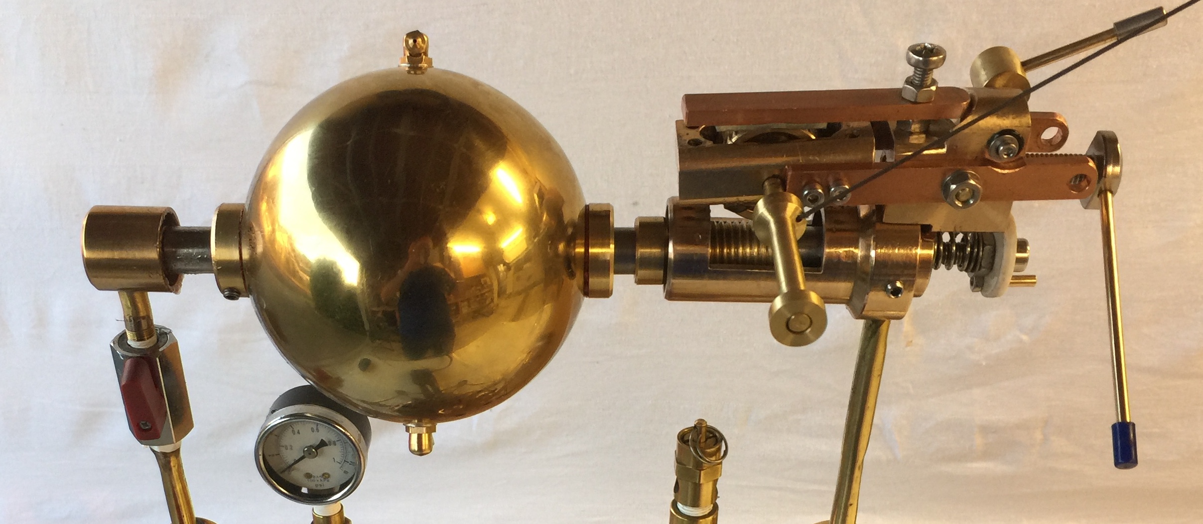 A banner photo of the spinning gold sphere of my new Hero's steam engine version 4