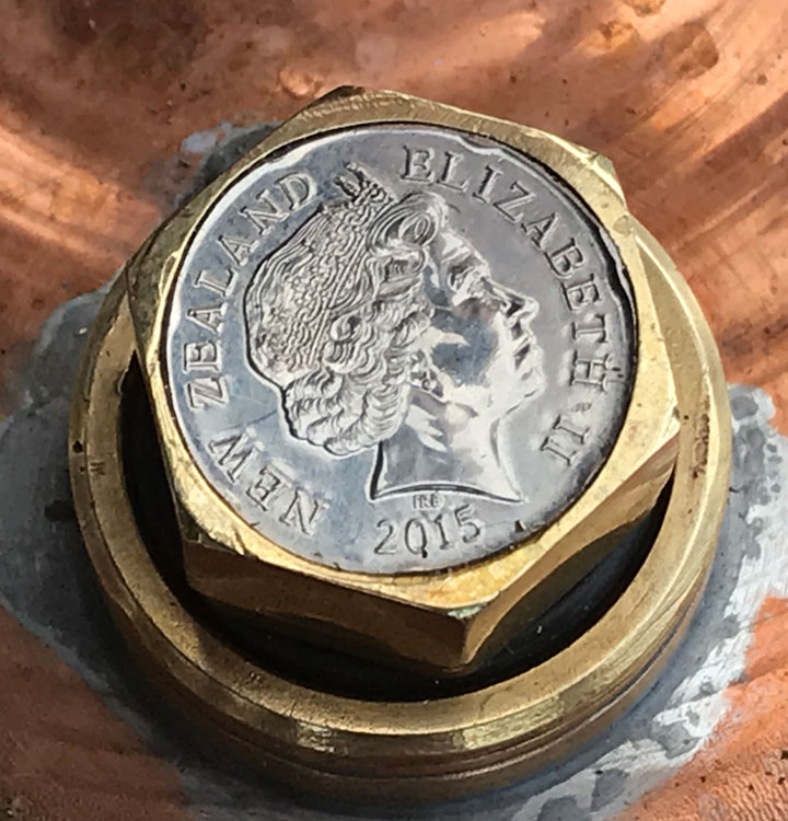 Photo of Queen Elizabeth 2 on a silver coin emdedded in the filler cap